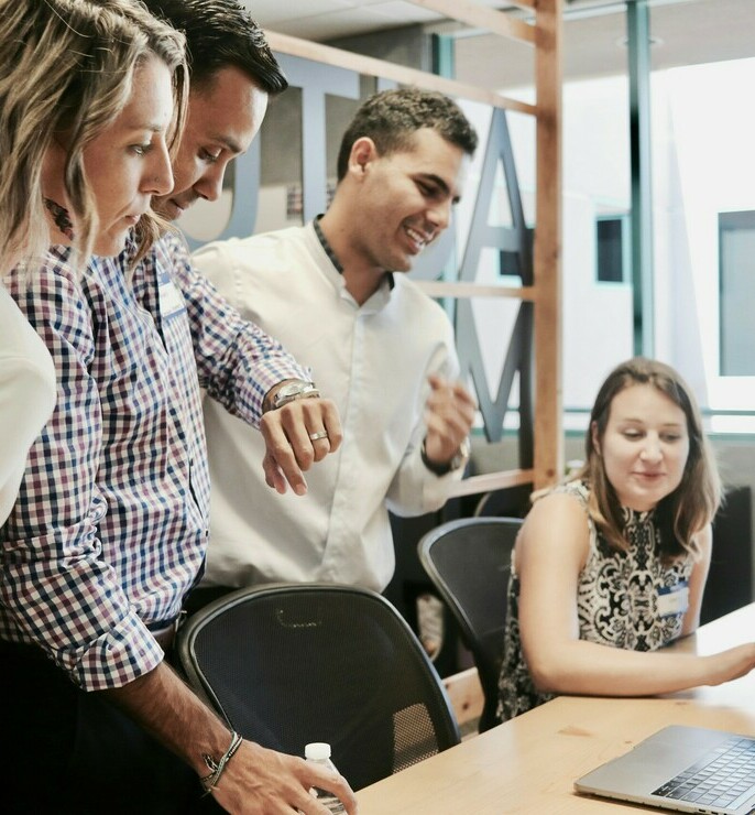 Picture of people looking at a laptop